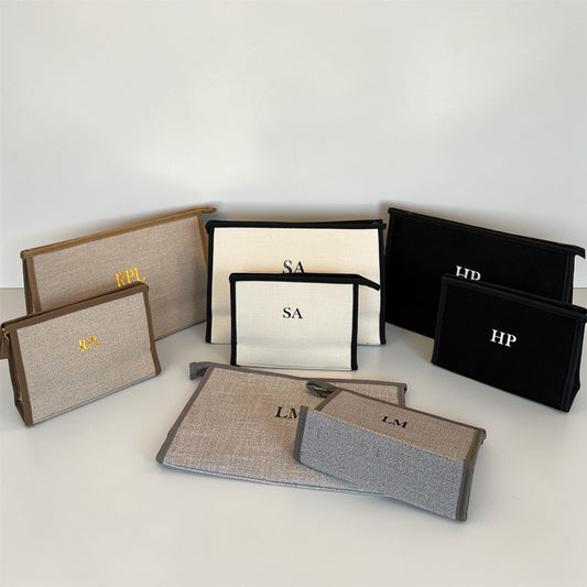 Collection of branded pouches and bags on a white surface